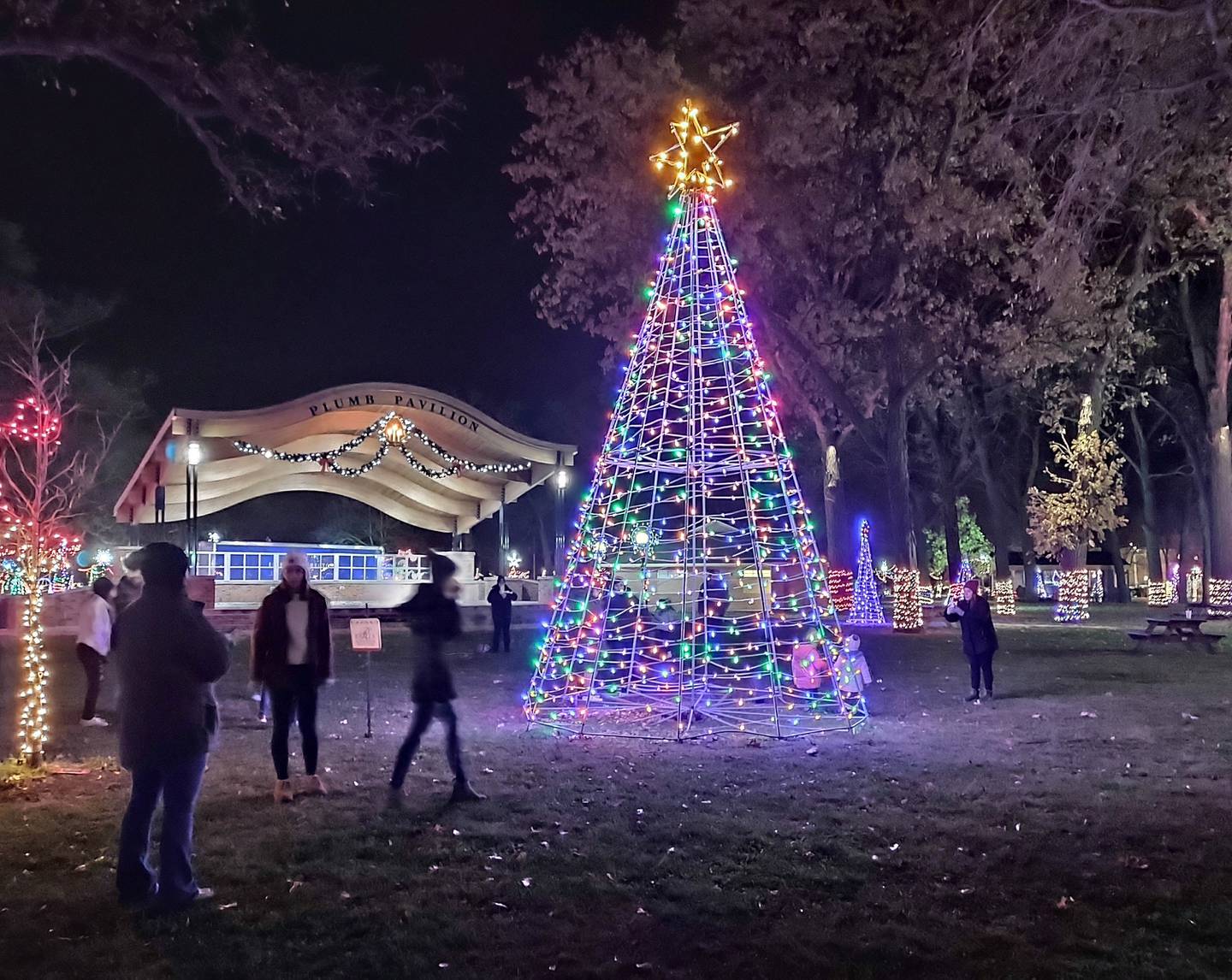 Visitors wander through City Park in Streator after it was illuminated Saturday, Nov. 27, by the Light Up Streator committee.