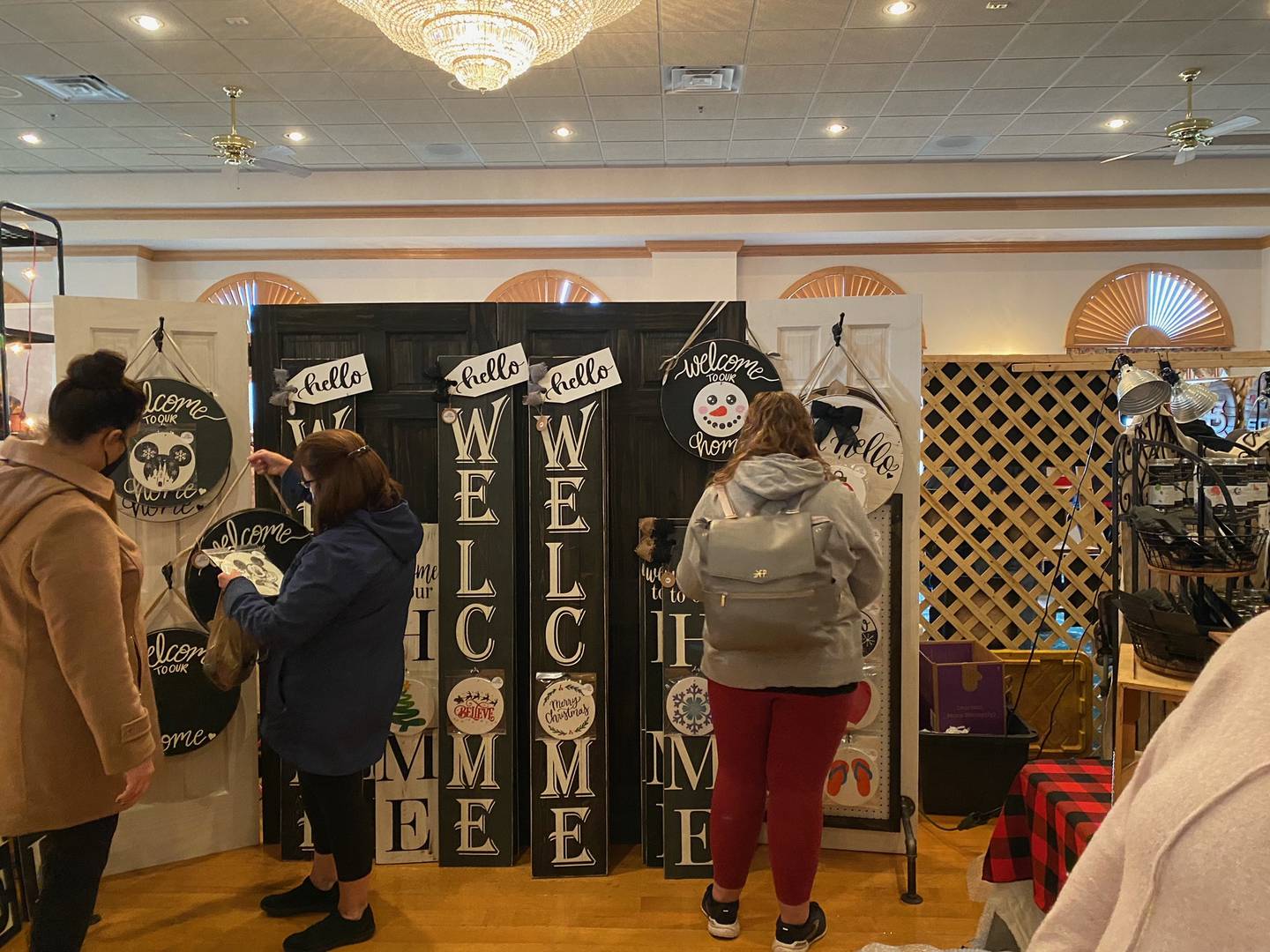 People view creations made at the 3 French Hens Holiday market that took place over the weekend in Morris.