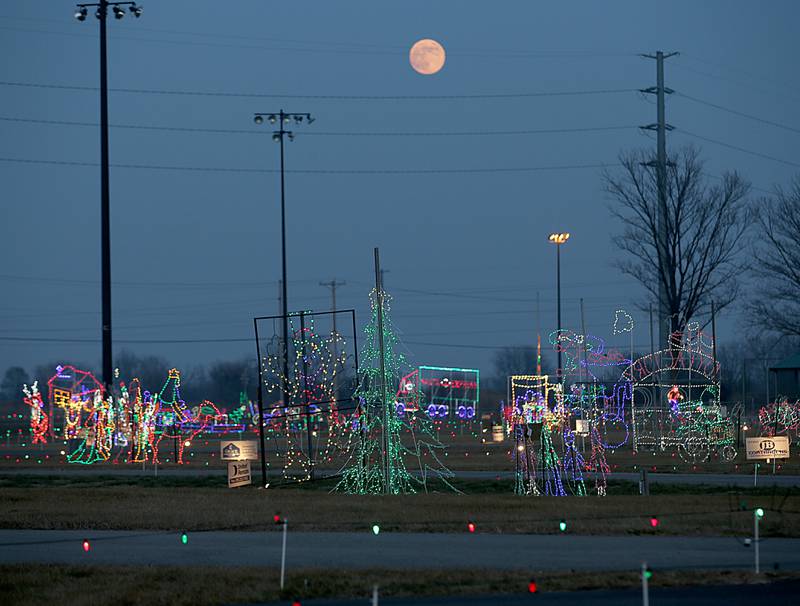 A full moon rises over Christmas decorations at the Celebration of Lights on Thursday, Dec. 8, 2022 at Rotary Park in La Salle.