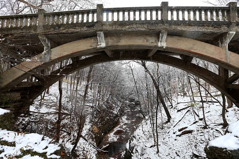 Snow falls into the canyon over the bridge on Tuesday, Nov. 15, 2022 at Matthiessen State Park in Oglesby.
