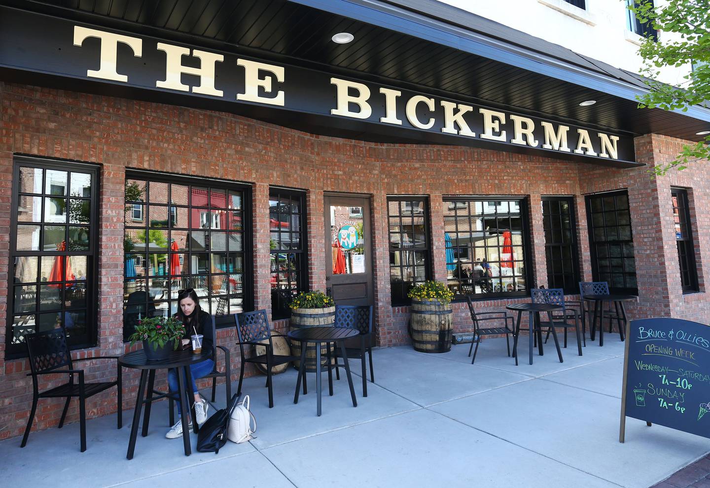 Kylie Mattioda works on her laptop in front of the newly remodeled The Bickerman building downtown Utica on Thursday May 13, 2021. Cetwinski family is excited to announce that the building will have space for gathering with friends, family, and new acquaintances that have come to visit our little slice of heaven. The business will be home to Bruce and Ollie’s serving Capannari's ice cream and coffee shop, offering locally-roasted Starved Rock Coffee Deli sandwiches, soups and salads.