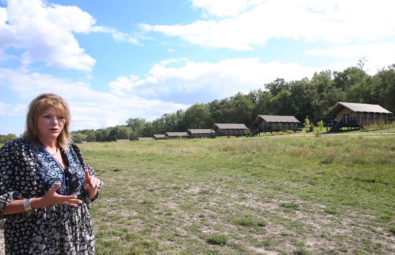 Jennifer Bias, owners of Camp Aramoni explains the 11 African style huts that can accommodate up to 50 guests on the property on Monday, Sept. 18, 2023 at Camp Araimoni. The upscale camping resort is featured cover of the fall winter 2023-2024 Enjoy Illinois magazine.