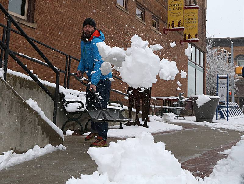 Pieter Van Drielen shovels snow on the sidewalk of the Lock 16 Cafe and Visitor Center on Wednesday, Jan. 25, 2023 downtown La Salle.