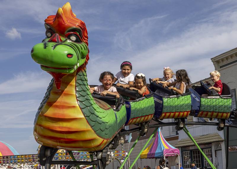 Children ride the dragon rollercoaster at the Mendota Sweet Corn Festival on August 11, 2024.