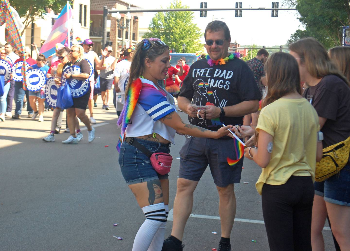 Marchers in the John Fisher Dann Memorial Pride Parade hand out treats to spectators during the Ottawa Family Pride Festival on Saturday, June 10, 2023.