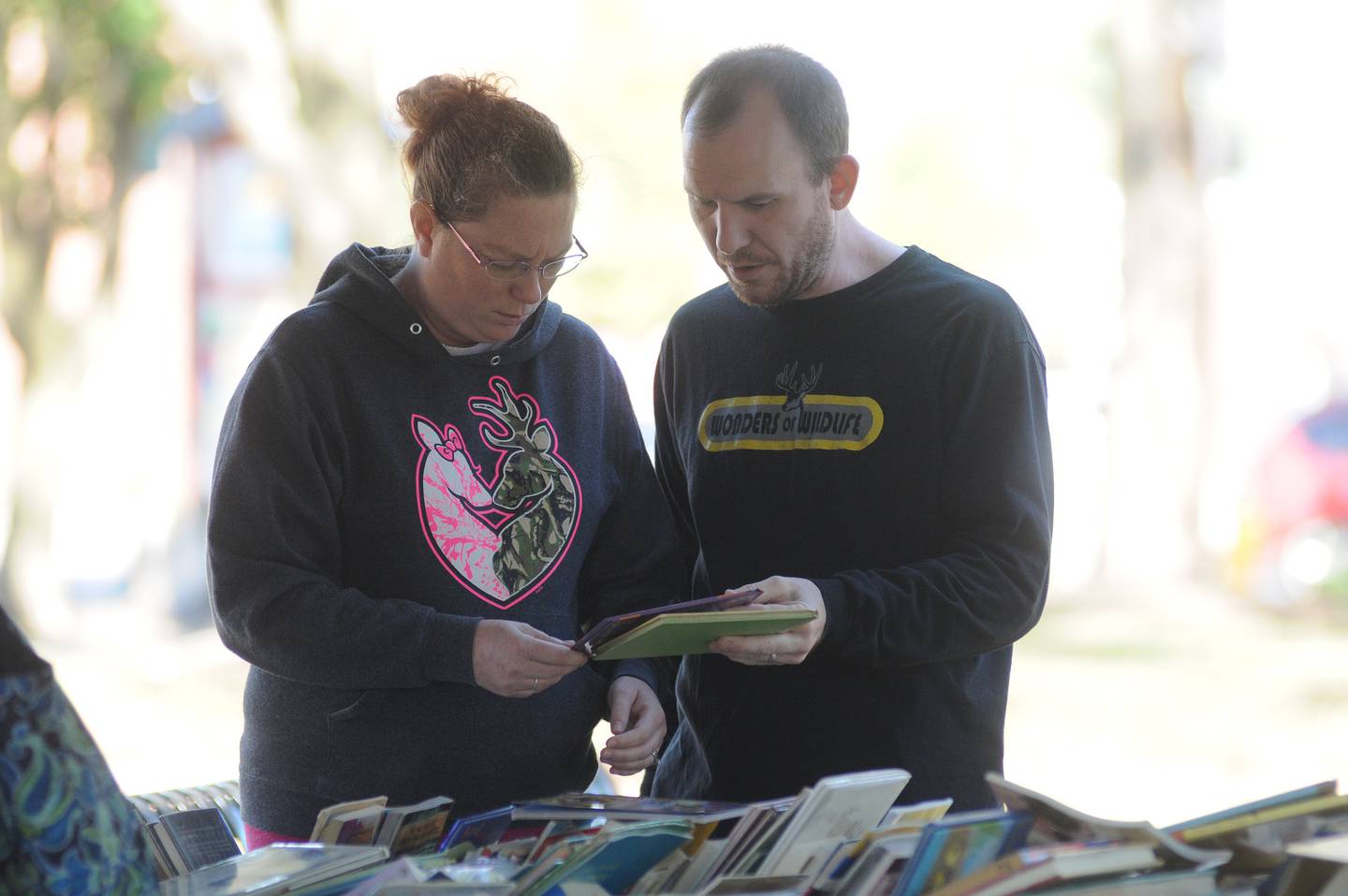 Virginia and Matt Maltas, of Ottawa, look at used books Saturday, Oct. 16, 2021, at the AAUW annual book sale during Lit Fest at Washington Square in Ottawa.