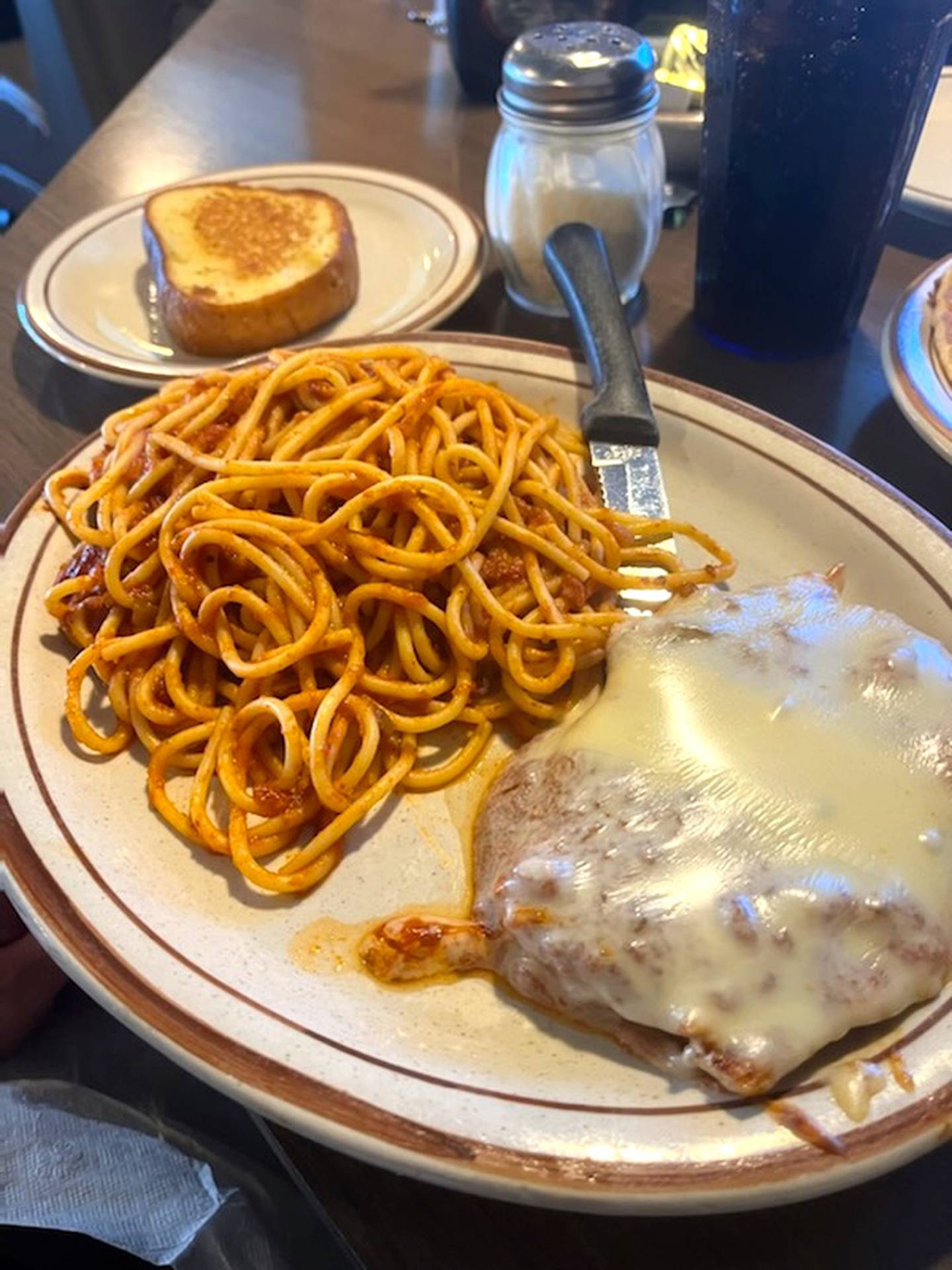 The chicken parmesan at the Coffee Cup in Princeton features a grilled chicken breast covered in sauce and cheese along with spaghetti and garlic bread.