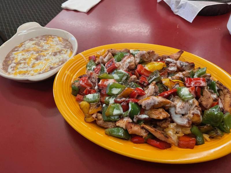 Mama's rice is a dish of grilled chicken (also available in beef) tossed with sauteed bell peppers and served over rice. It's one of the Mexican dishes available at Jorge's Margaritas & Grill in La Salle, which also offers local favorites such as sandwiches, ribeye fried chicken and cod.