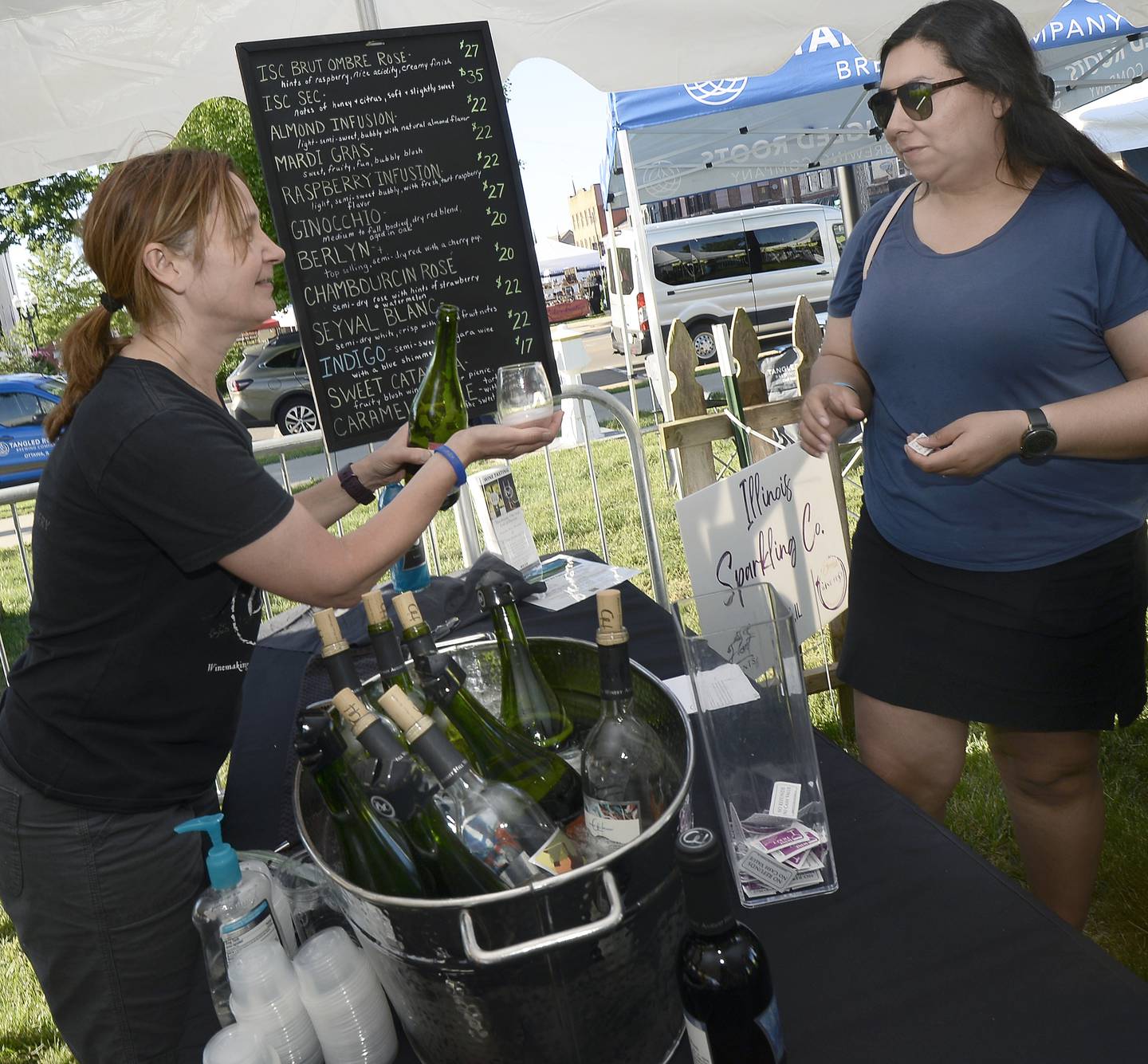 Laurie Smudzinski of August Hill Winery pours a sample of wine for a customer Friday, June 3, 2022, at Wine Fest in Ottawa. The festival runs through Sunday.