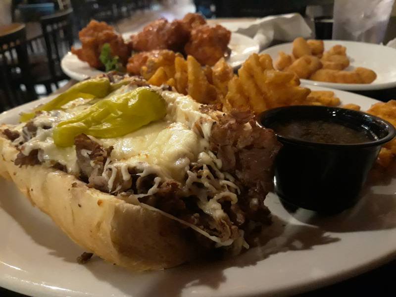 The Italian beef at Riverfront Bar and Grill in Peru is served with stacks of seasoned meat and loads of mozzarella cheese on a toasted bun with pepperoncinis and au jus.