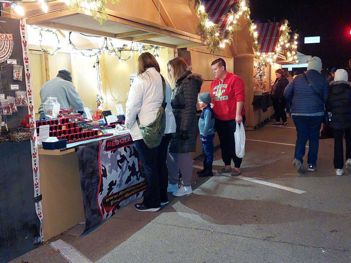 Shoppers patronize a vendor Friday, Dec. 15, 2023, during the Chris Kringle Market in Ottawa.