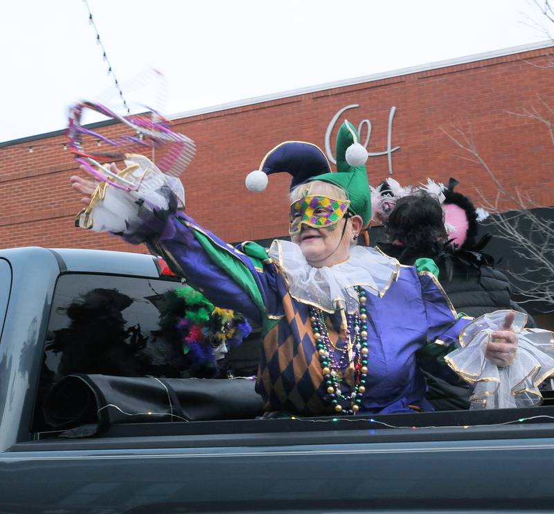 Dressed in their Mardi Gras finest, those riding in the annual Mardi Gras parade Saturday, Feb. 18, 2023, tossed beads and candy treats to those gathered along Mill Street in Utica. The parade was sponsored by the Utica Business Association.