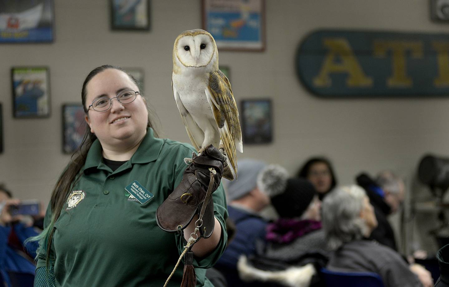 Beth Chan, of the Illinois Raptor Center, shows a barn owl to the audience Saturday, Jan. 28, 2023, at the Illinois Waterway Visitors Center during the Illinois Birds Of Prey program as part of the Eagle Watch Weekend.
