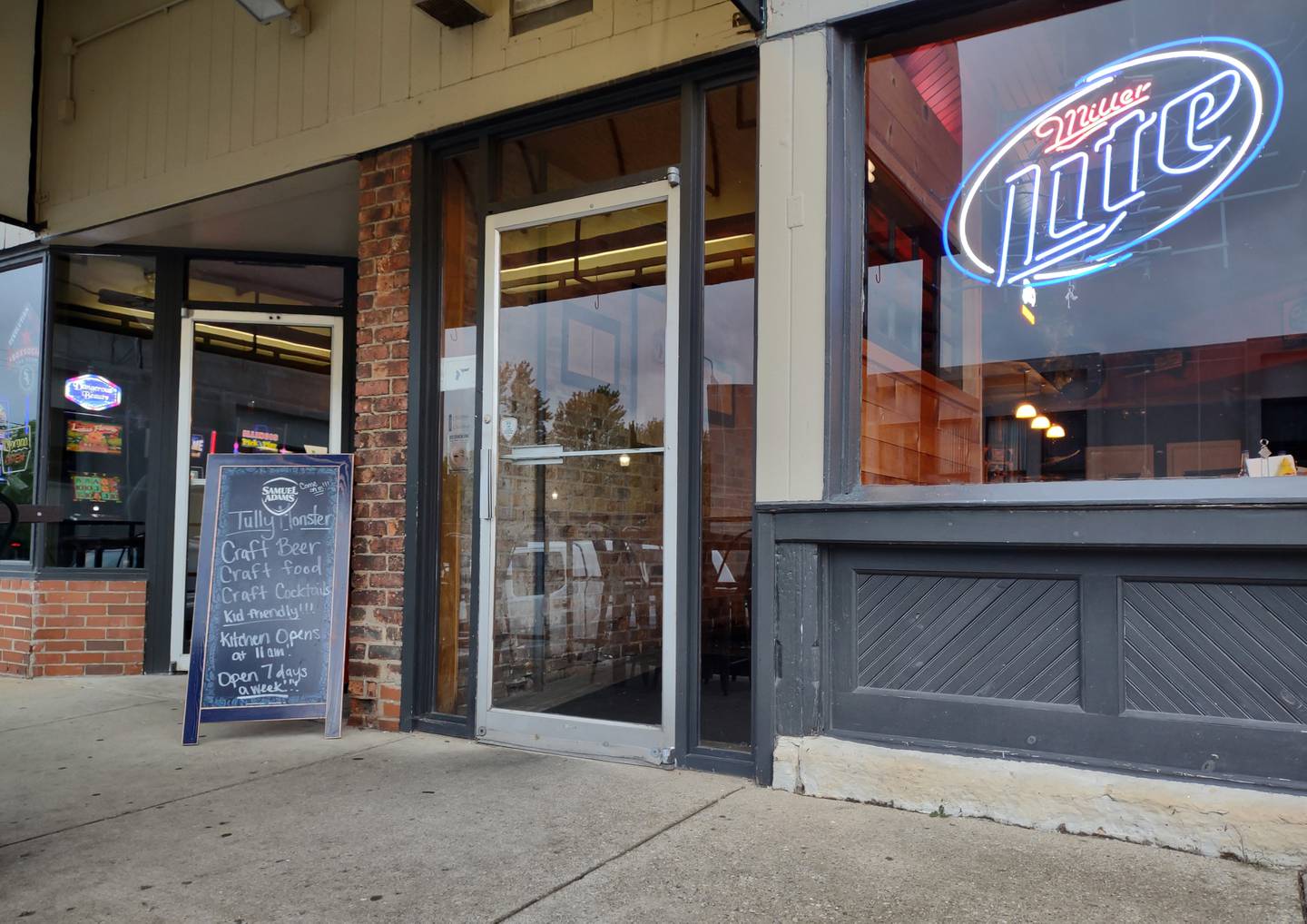 The A-frame chalkboard sign marks the entrance of Tully Monster Pub & Grill on the west side of Liberty Street in downtown Morris.