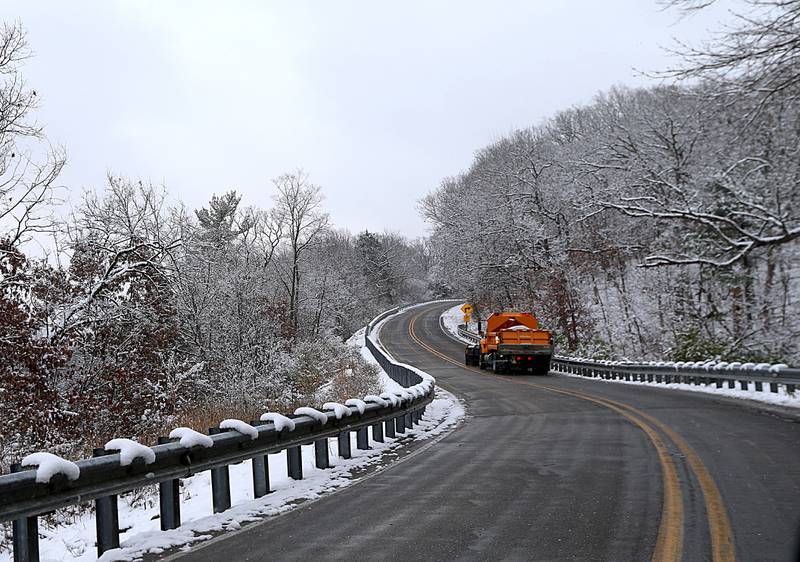 A snowplow maneuvers through the curves on Illinois Route 71 through Starved Rock State Park on Tuesday, Nov. 15, 2022.