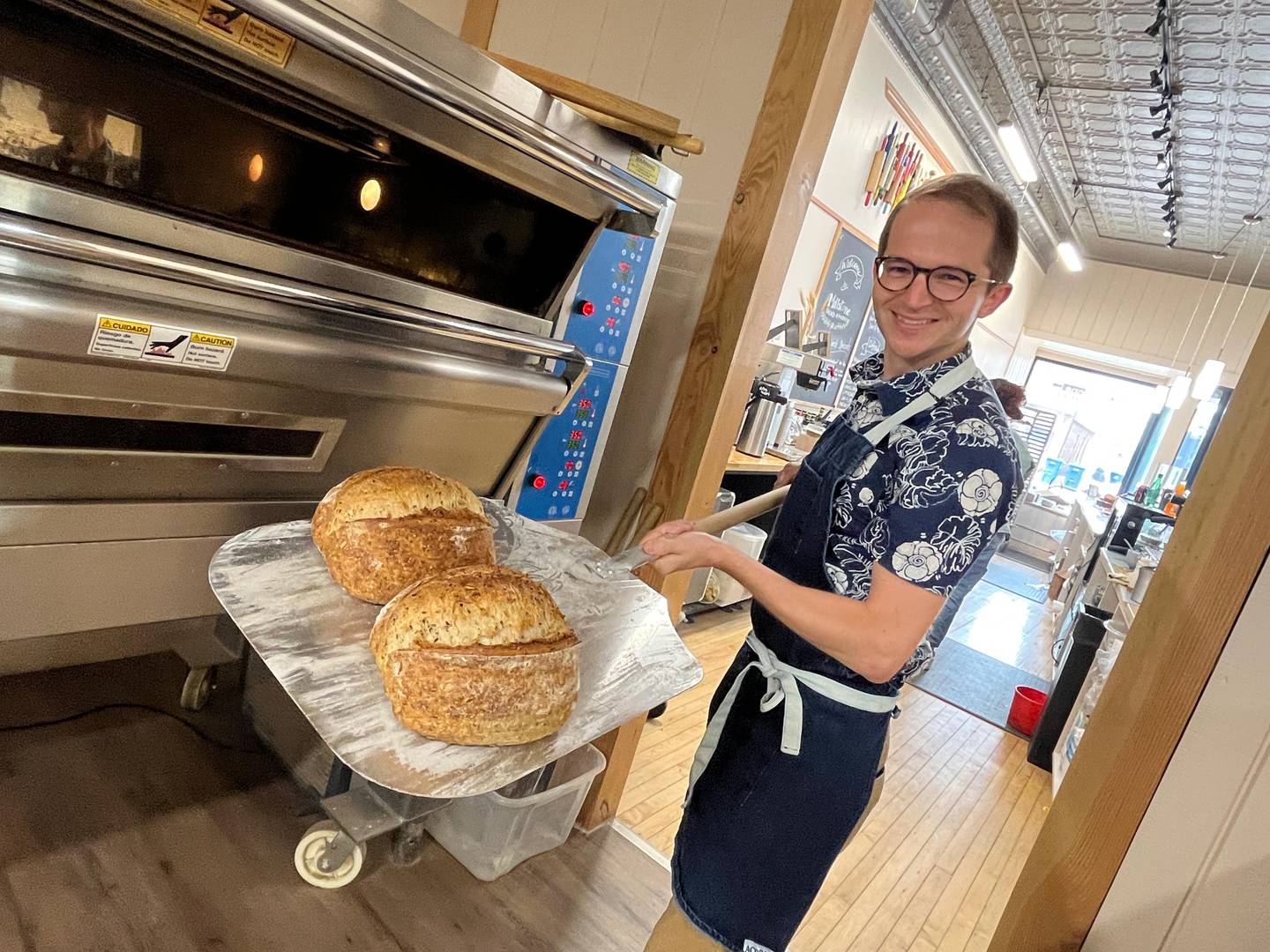 Co-owner Kent Maze displays examples of the artisan breads created at Millstone Bakery in La Salle, singled out for recognition by Illinois Made.